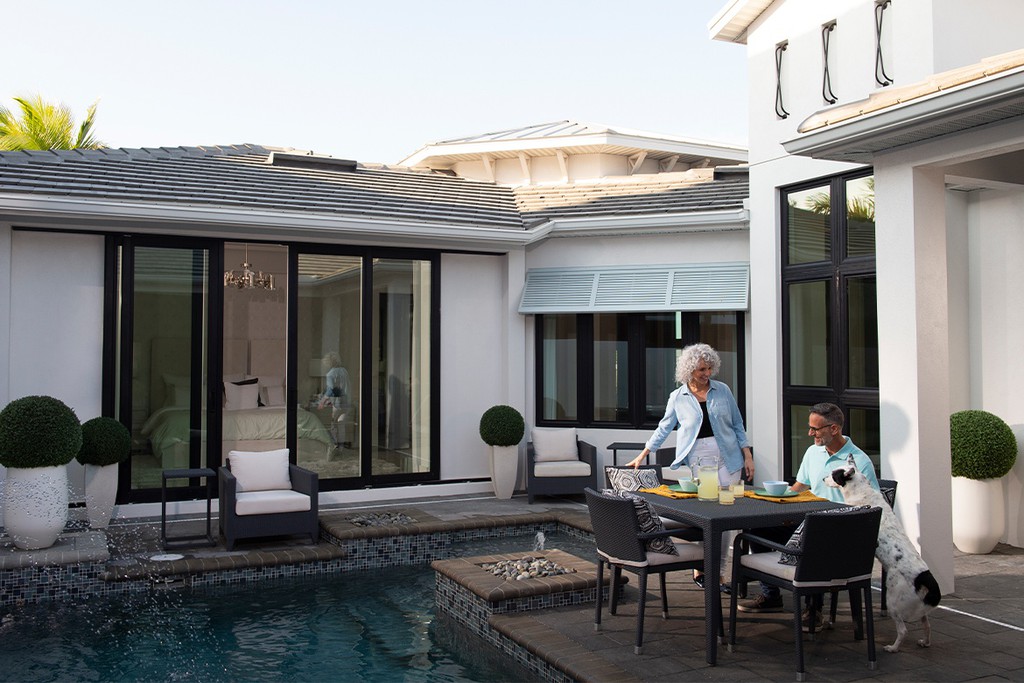 People outside house with pool